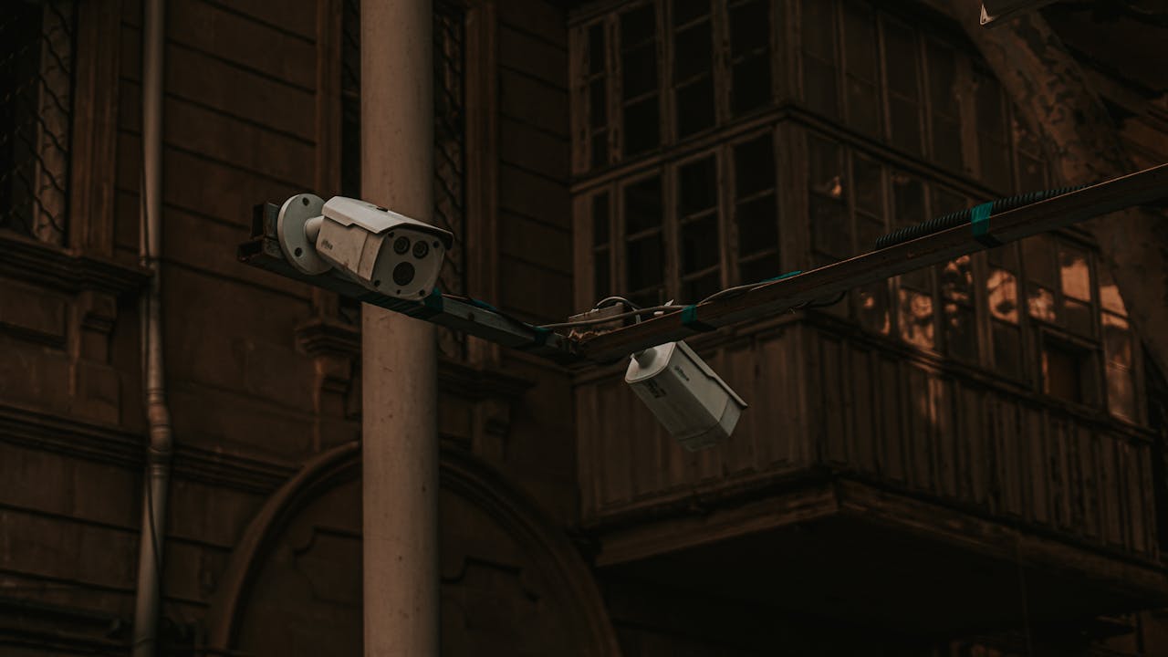 about-us Street security cameras mounted on a pole in an urban environment, highlighting surveillance.