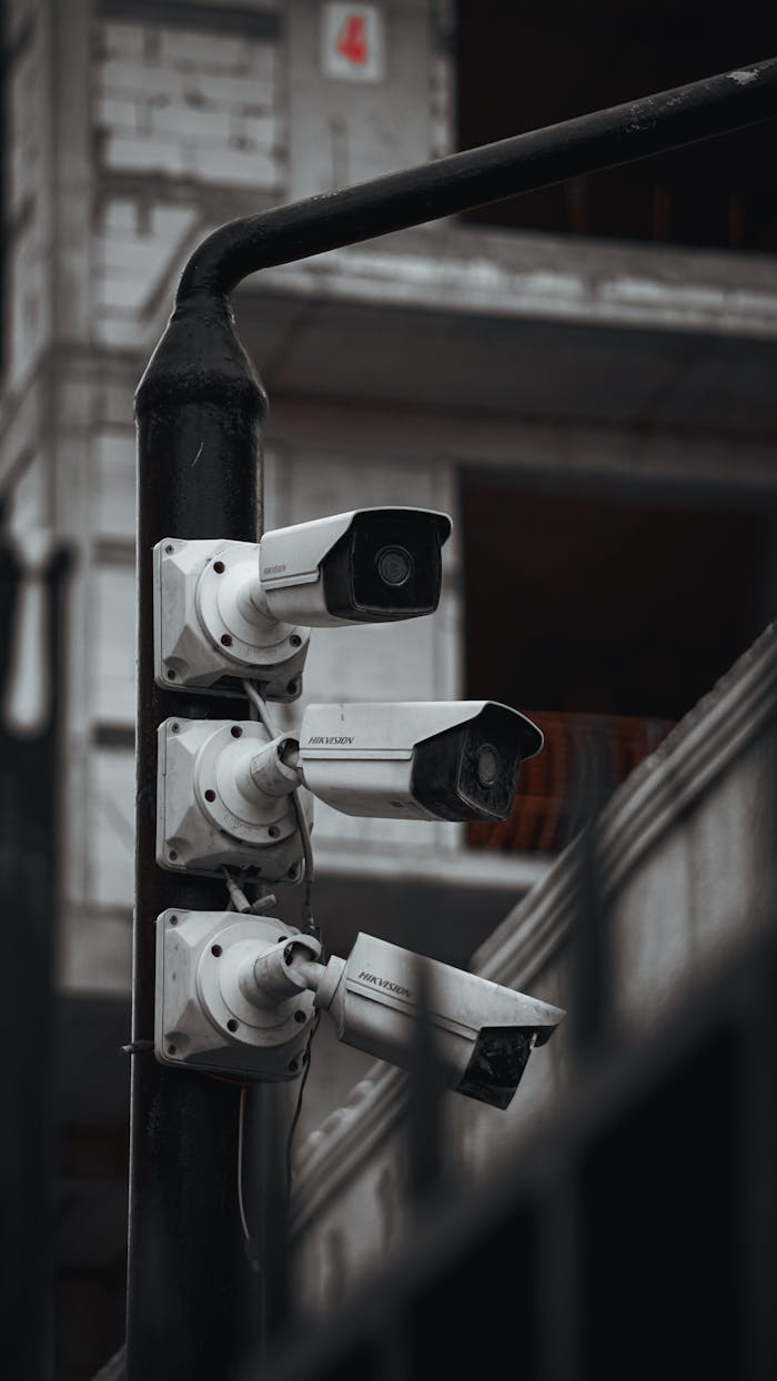 services-04 Array of security cameras on a building post, highlighting surveillance and urban security.